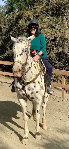 Woman mounted on a speckled horse