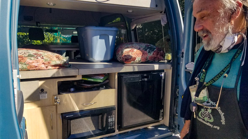 Rob Kleinschmidt in front of his Ford Transit Connect camper van. 