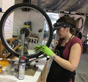 woman truing a bicycle wheel